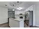 Updated kitchen with white cabinets, granite countertops, stainless steel appliances, and a stylish island at 3573 Plantation Pl, Loganville, GA 30052