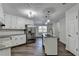 Modern kitchen features white cabinetry, stainless steel appliances, granite countertops, and an island at 3573 Plantation Pl, Loganville, GA 30052