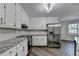 Well-equipped kitchen boasts stainless steel appliances, granite countertops, and ample cabinet space at 3573 Plantation Pl, Loganville, GA 30052