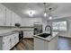 Renovated kitchen showcasing stainless steel appliances, granite countertops, and a kitchen island at 3573 Plantation Pl, Loganville, GA 30052