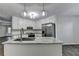 Bright kitchen featuring white cabinets, stainless steel appliances, and a center island with granite countertops at 3573 Plantation Pl, Loganville, GA 30052