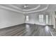 Large living room showing hardwood floors, ceiling fan, and access to the back yard at 3573 Plantation Pl, Loganville, GA 30052