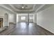 Bright living room with tray ceiling, neutral walls, and clear view of the front entrance at 3573 Plantation Pl, Loganville, GA 30052