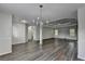 Expansive living room features new flooring, a tray ceiling, and natural light at 3573 Plantation Pl, Loganville, GA 30052