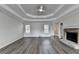 Spacious living room features new flooring, a tray ceiling, natural light, and a fireplace at 3573 Plantation Pl, Loganville, GA 30052