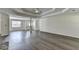 Large living room with tray ceiling and hardwood floors provides ample space for furniture and decor at 3573 Plantation Pl, Loganville, GA 30052