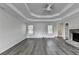 Large living room showing hardwood floors, tray ceiling, and fireplace at 3573 Plantation Pl, Loganville, GA 30052