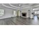 Spacious living room with a stone fireplace and tray ceiling offers a cozy and stylish gathering space at 3573 Plantation Pl, Loganville, GA 30052