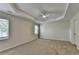 Spacious primary bedroom featuring a tray ceiling at 3573 Plantation Pl, Loganville, GA 30052