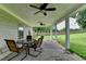 Covered patio with ceiling fans offers outdoor dining with a backyard view at 3573 Plantation Pl, Loganville, GA 30052