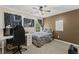 Comfortable bedroom featuring a ceiling fan, a carpeted floor, and a desk at 7090 River Island Cir, Buford, GA 30518