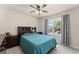Cozy bedroom featuring a ceiling fan and a window with curtains at 7090 River Island Cir, Buford, GA 30518