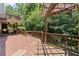 Spacious wooden deck featuring a pergola, wooden railings, and ample space for outdoor seating at 7090 River Island Cir, Buford, GA 30518
