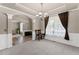 Open-concept dining room with modern lighting, neutral tones, and elegant trim details at 7090 River Island Cir, Buford, GA 30518