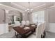 Spacious dining room featuring elegant chandelier, wainscoting, and an arched entryway at 7090 River Island Cir, Buford, GA 30518