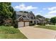 Inviting two-story home featuring a two-car garage and well-kept front yard at 7090 River Island Cir, Buford, GA 30518