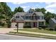Charming two-story home with a well-maintained lawn, complemented by a two-car garage at 7090 River Island Cir, Buford, GA 30518
