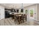 Spacious eat-in kitchen featuring dark wood cabinetry, island, and stainless steel appliances at 7090 River Island Cir, Buford, GA 30518