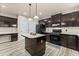 This kitchen has dark cabinetry, stainless appliances, a center island and eat-in counter space at 7090 River Island Cir, Buford, GA 30518
