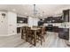 Open kitchen features dark cabinetry, stainless appliances, kitchen island, and eat-in dining area at 7090 River Island Cir, Buford, GA 30518