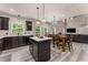 Eat-in kitchen with black appliances, dark cabinets, eat-in table, and lots of counter space at 7090 River Island Cir, Buford, GA 30518