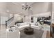 Bright, open living room with modern staircase, fireplace and seamless flow into the kitchen and dining area at 7090 River Island Cir, Buford, GA 30518