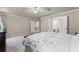 Spacious bedroom with a tray ceiling, carpet, and multiple closets and access to bathroom at 7090 River Island Cir, Buford, GA 30518