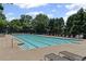 Large community pool surrounded by lounge chairs, ideal for relaxation and recreation at 7090 River Island Cir, Buford, GA 30518