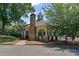 Charming pool house featuring stone accents and shaded seating, located near the community pool at 7090 River Island Cir, Buford, GA 30518