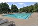 Well-maintained community pool with multiple lounge chairs for relaxing and enjoying the sun at 7090 River Island Cir, Buford, GA 30518