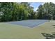 Well-maintained tennis court surrounded by trees, perfect for recreational play at 7090 River Island Cir, Buford, GA 30518