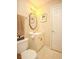 Cozy bathroom features a toilet, vanity with storage, mirror, and lighting at 177 Rustin Dr, Dallas, GA 30157