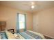 Bright bedroom featuring a bed with patterned linens and a window with sheer curtains at 177 Rustin Dr, Dallas, GA 30157