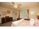 Cozy bedroom with neutral tones, a ceiling fan, and a window providing natural light at 177 Rustin Dr, Dallas, GA 30157
