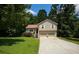 Charming two-story home featuring a two-car garage, red front door, and a well-maintained lawn surrounded by mature trees at 177 Rustin Dr, Dallas, GA 30157