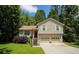 Charming two-story home with attached two-car garage and a red front door surrounded by green trees at 177 Rustin Dr, Dallas, GA 30157