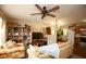 Comfortable living room with a ceiling fan, bookshelves and an open floorplan leading to the kitchen at 177 Rustin Dr, Dallas, GA 30157