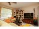 Bright and airy living room with a ceiling fan, large window, cozy seating, and ample storage space at 177 Rustin Dr, Dallas, GA 30157