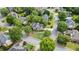 An aerial view showcases a neighborhood with winding streets and lush greenery surrounding well-kept homes at 295 Sagamore Nw Cv, Sugar Hill, GA 30518