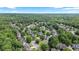 Beautiful aerial view of a wooded neighborhood with mature trees and well-maintained homes at 295 Sagamore Nw Cv, Sugar Hill, GA 30518