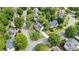 Aerial view of a neighborhood with sidewalks, mature trees, and well-manicured lawns at 295 Sagamore Nw Cv, Sugar Hill, GA 30518