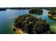 Beautiful aerial view of lake with islands and clear waters at 295 Sagamore Nw Cv, Sugar Hill, GA 30518
