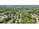 Expansive aerial view of a residential community nestled among lush green trees and winding roads at 295 Sagamore Nw Cv, Sugar Hill, GA 30518