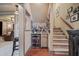 A bar with a beverage fridge is next to the stairs at 295 Sagamore Nw Cv, Sugar Hill, GA 30518