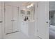 Clean bathroom featuring a vanity and dual-door closet at 295 Sagamore Nw Cv, Sugar Hill, GA 30518