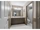 Elegant bathroom featuring a large mirror, vanity and a toilet with a shower nearby at 295 Sagamore Nw Cv, Sugar Hill, GA 30518