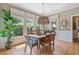 Charming dining area featuring natural light and a stylish chandelier at 295 Sagamore Nw Cv, Sugar Hill, GA 30518