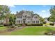 Charming two-story home boasts lush front lawn and mature landscaping at 295 Sagamore Nw Cv, Sugar Hill, GA 30518