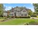 Beautiful two-story traditional home with manicured lawn, tasteful landscaping and a welcoming front porch at 295 Sagamore Nw Cv, Sugar Hill, GA 30518