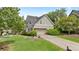 Charming two-story home with a lush green lawn, well-maintained landscaping, and attached garage at 295 Sagamore Nw Cv, Sugar Hill, GA 30518